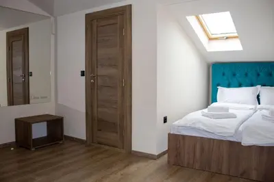 a bedroom with a bed and a skylight at ELEVENROOMS in Belgrade