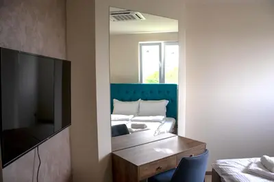 a living room with a television and a bed at ELEVENROOMS in Belgrade
