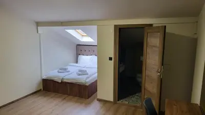 a bedroom with a bed and an open door at ELEVENROOMS in Belgrade