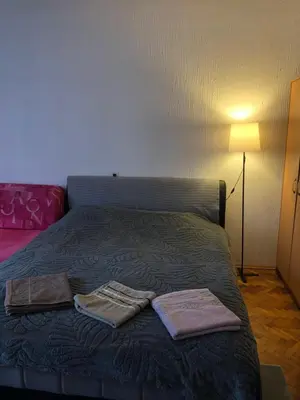 a bedroom with a bed with two towels on it at MAXIMUS VRACAR in Belgrade