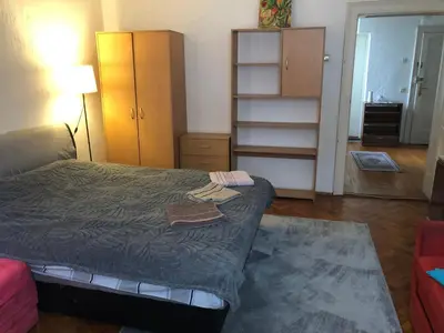 a small bedroom with a bed and a dresser at MAXIMUS VRACAR in Belgrade