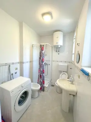 a bathroom with a washing machine and a sink at MAXIMUS VRACAR in Belgrade