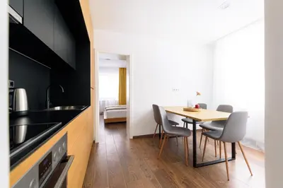 a kitchen with a table and chairs in a room at Tim 3 in Belgrade