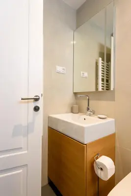 a bathroom with a white sink and a mirror at Tim 3 in Belgrade