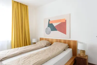 a bedroom with a bed and a yellow curtain at Tim 3 in Belgrade