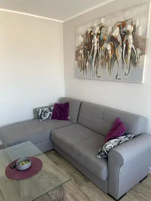 a living room with a couch and a painting on the wall at Viewpoint in Belgrade