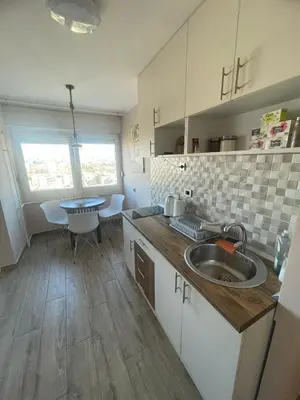 a kitchen with a sink and a table in it at Viewpoint in Belgrade