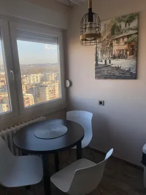 a table and chairs in a room with a window at Viewpoint in Belgrade
