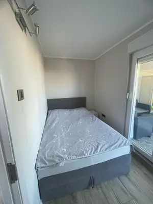 a small bedroom with a bed in the corner at Viewpoint in Belgrade