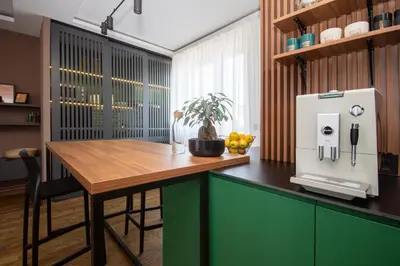 a kitchen with a wooden table and a refrigerator at Artisan's Dwelling in Belgrade
