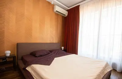 a bedroom with a bed and a window with avertisement at Artisan's Dwelling in Belgrade
