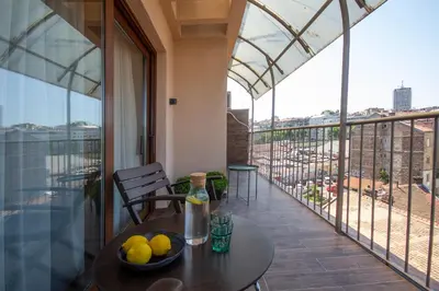 a balcony with a table with a bowl of fruit on it at Artisan's Dwelling in Belgrade