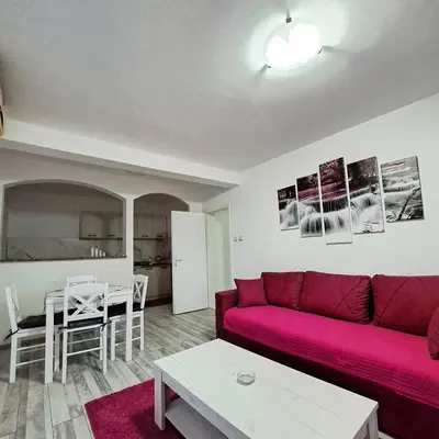 a living room with a red couch and a table at Apartman Giovanni 2 in Arandjelovac