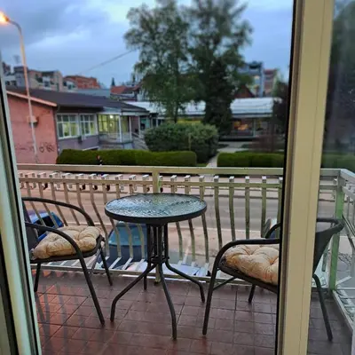 a table and two chairs on a balcony at Apartman Giovanni 2 in Arandjelovac
