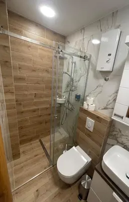 a bathroom with a glass shower and a toilet at Sofie - free parking place in the garage in Belgrade