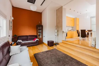 a living room with a couch and a kitchen at Apartman Kalvarija in Belgrade