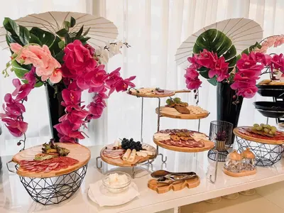 a table with many plates of food and flowers at LDS Hotel Belgrade in Belgrade