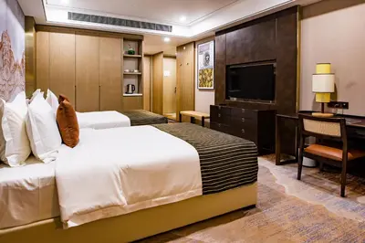 a hotel room with two beds and a flat screen tv at LDS Hotel Belgrade in Belgrade