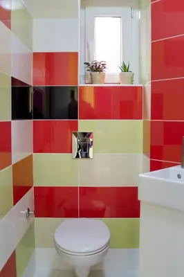 a colorful bathroom with a toilet and a sink at Hostel Bongo in Belgrade