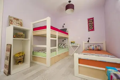 a kids room with two bunk beds and a desk at Hostel Bongo in Belgrade