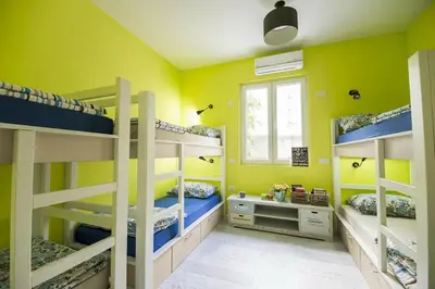 a room with three bunk beds and a window at Hostel Bongo in Belgrade