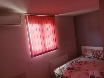 a bedroom with a bed with a red window at ViP ROOMS PRENOCISTE 026 in Smederevo