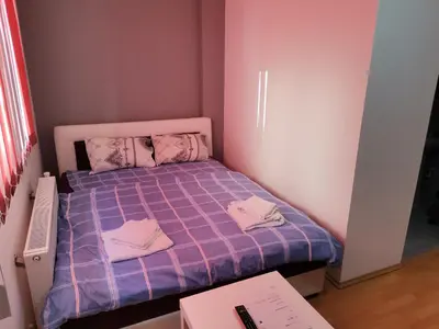 a small bedroom with a purple bed with towels on it at ViP ROOMS PRENOCISTE 026 in Smederevo