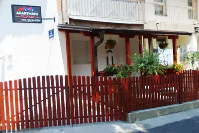 a red fence in front of a house at Apartmani Glorija in Arandjelovac