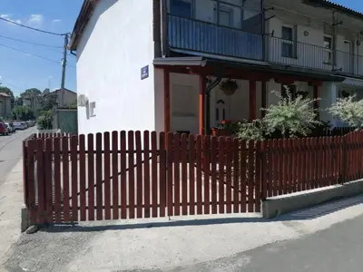 a red fence in front of a house at Apartmani Glorija in Arandjelovac
