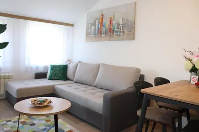 a living room with a couch and a table at Apartman Mila 21 in Zvezdara