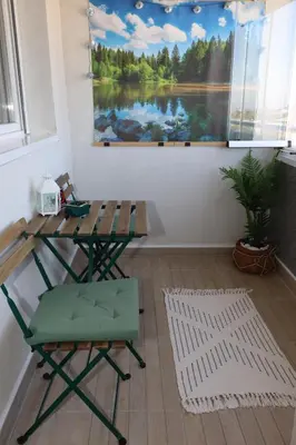 a table and chair in a room with a painting at Apartman Mila 21 in Zvezdara