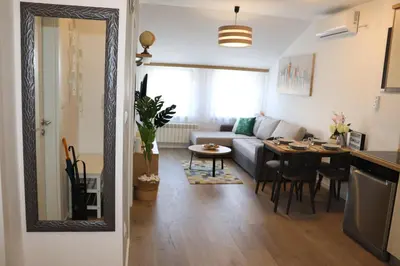 a living room with a couch and a table at Apartman Mila 21 in Zvezdara