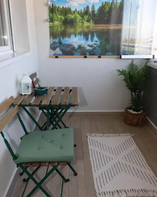 a table and chair in a room with a painting at Apartman Mila 21 in Zvezdara