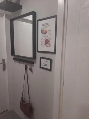 a mirror hanging on a wall next to a door at AVALA, New Belgrade in Fontana