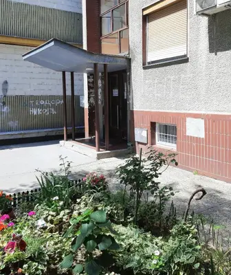 a building with awning and flowers in front of it at AVALA, New Belgrade in Fontana