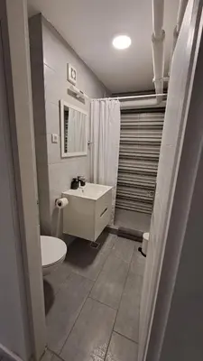 a bathroom with a white toilet and a sink at AVALA, New Belgrade in Fontana