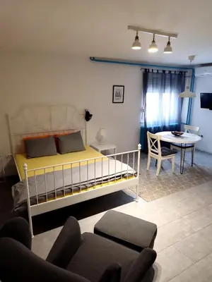 a bedroom with a bed and a table and a couch at AVALA, New Belgrade in Fontana