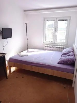 a bedroom with a large bed with a window at Itaka - Belgrade City Center in Belgrade