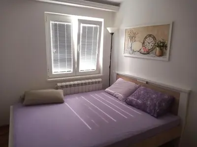 a bed in a room with a window at Itaka - Belgrade City Center in Belgrade