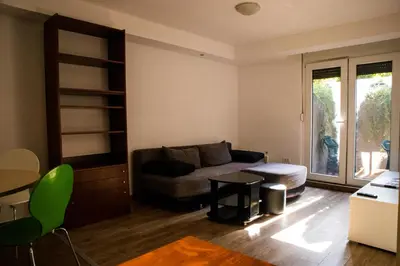 a living room with a couch and a table at Dukes Apartment in Belgrade