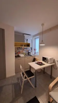 a kitchen with a table with a laptop on it at ADA, New Belgrade in Tošin Bunar
