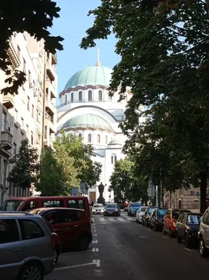 a domed building with cars parked on a city street at KaLuMa in Belgrade