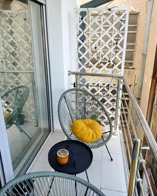 a balcony with a chair and a table at KaLuMa in Belgrade