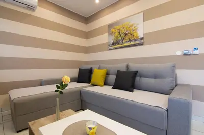 a living room with a couch and a table at Jana apartmani in Novi Grad