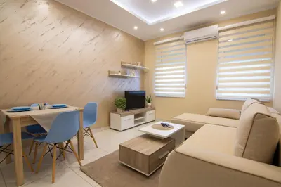 a living room with a couch and a table at Jana apartmani in Novi Grad