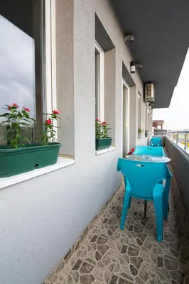 a row of blue sinks in a room with windows at Jana apartmani in Novi Grad