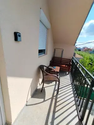 a balcony with a chair and a window at A1 - Airport Belgrade Apartment in Belgrade