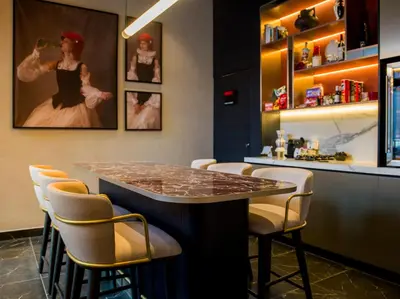 a bar with a table and chairs in a room at Radisson RED Belgrade in Belgrade