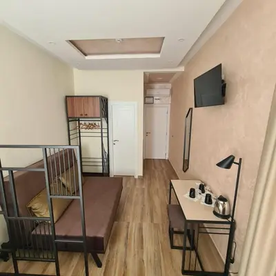 a small room with a bunk bed and a table at Up Hostel in Belgrade