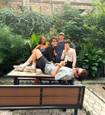 a group of people sitting on a picnic table at Up Hostel in Belgrade